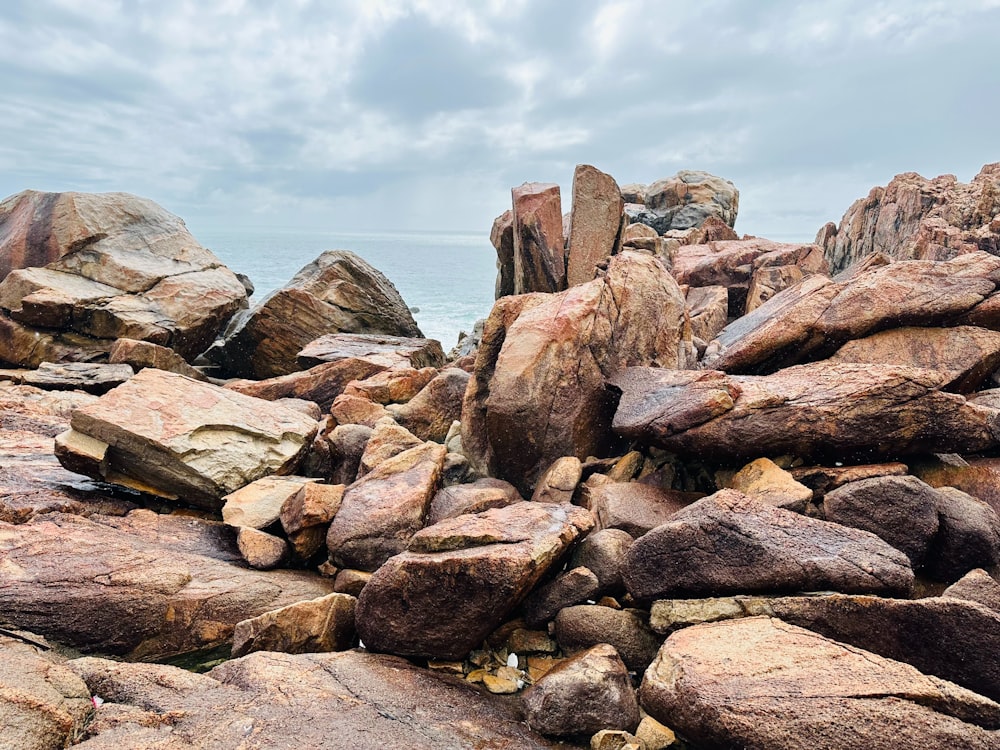 a pile of rocks sitting on top of a beach