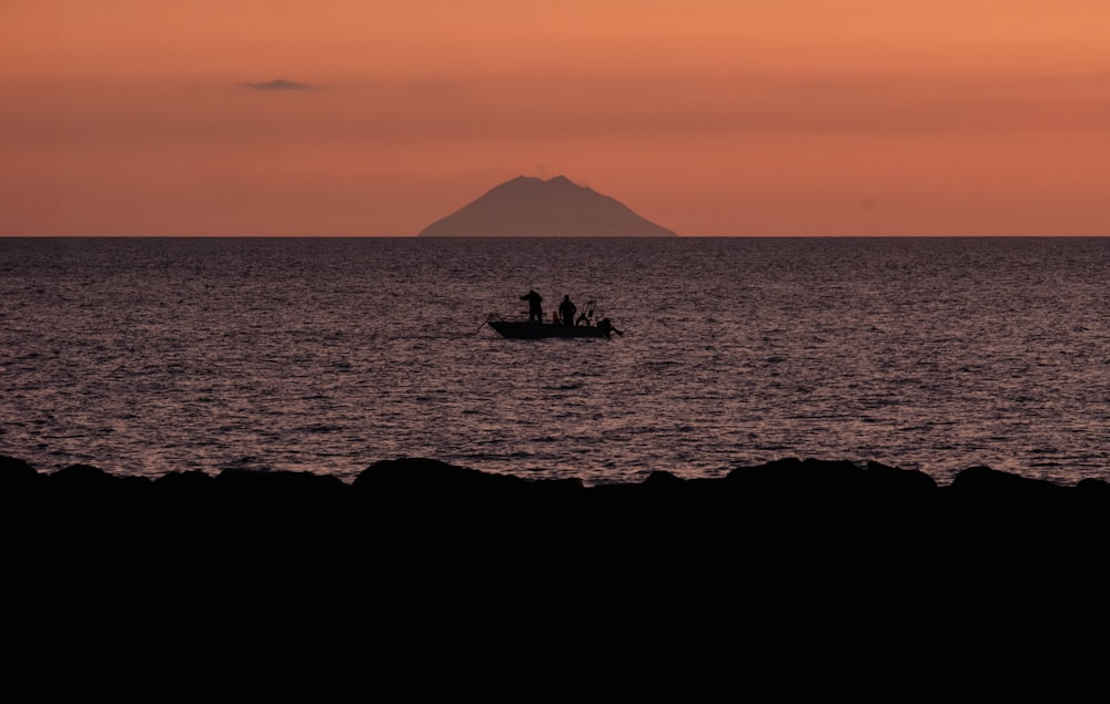 a couple of people in a small boat in the ocean