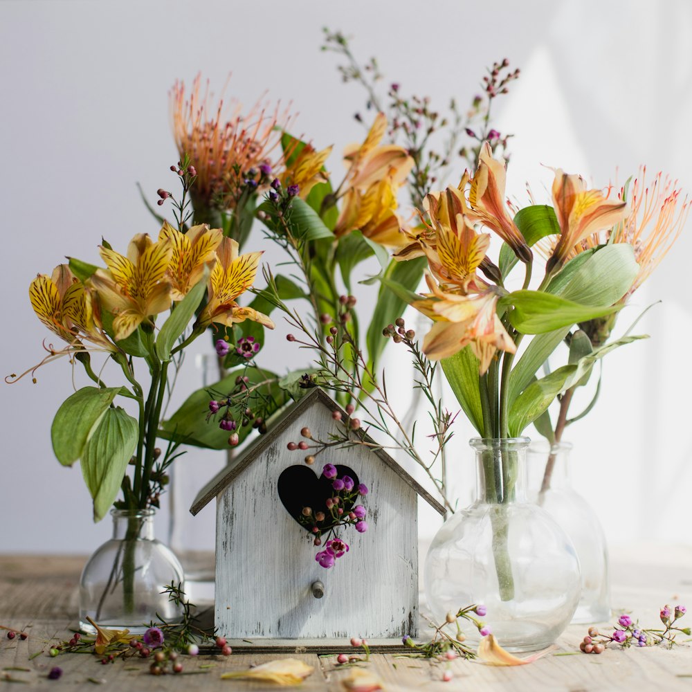 a group of vases filled with flowers on top of a table