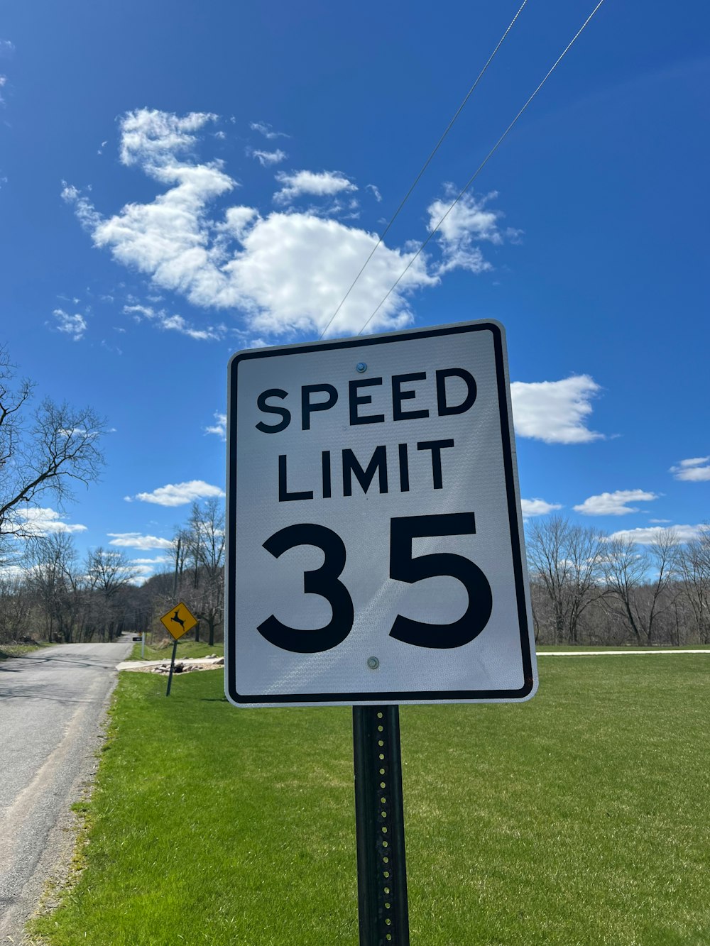 a speed limit sign on the side of a road