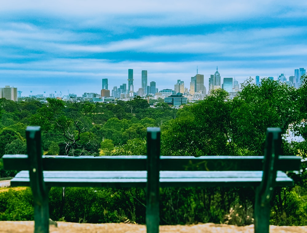 a view of a city from a park bench