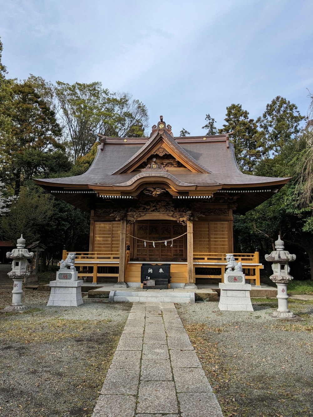 a small wooden structure with statues in front of it