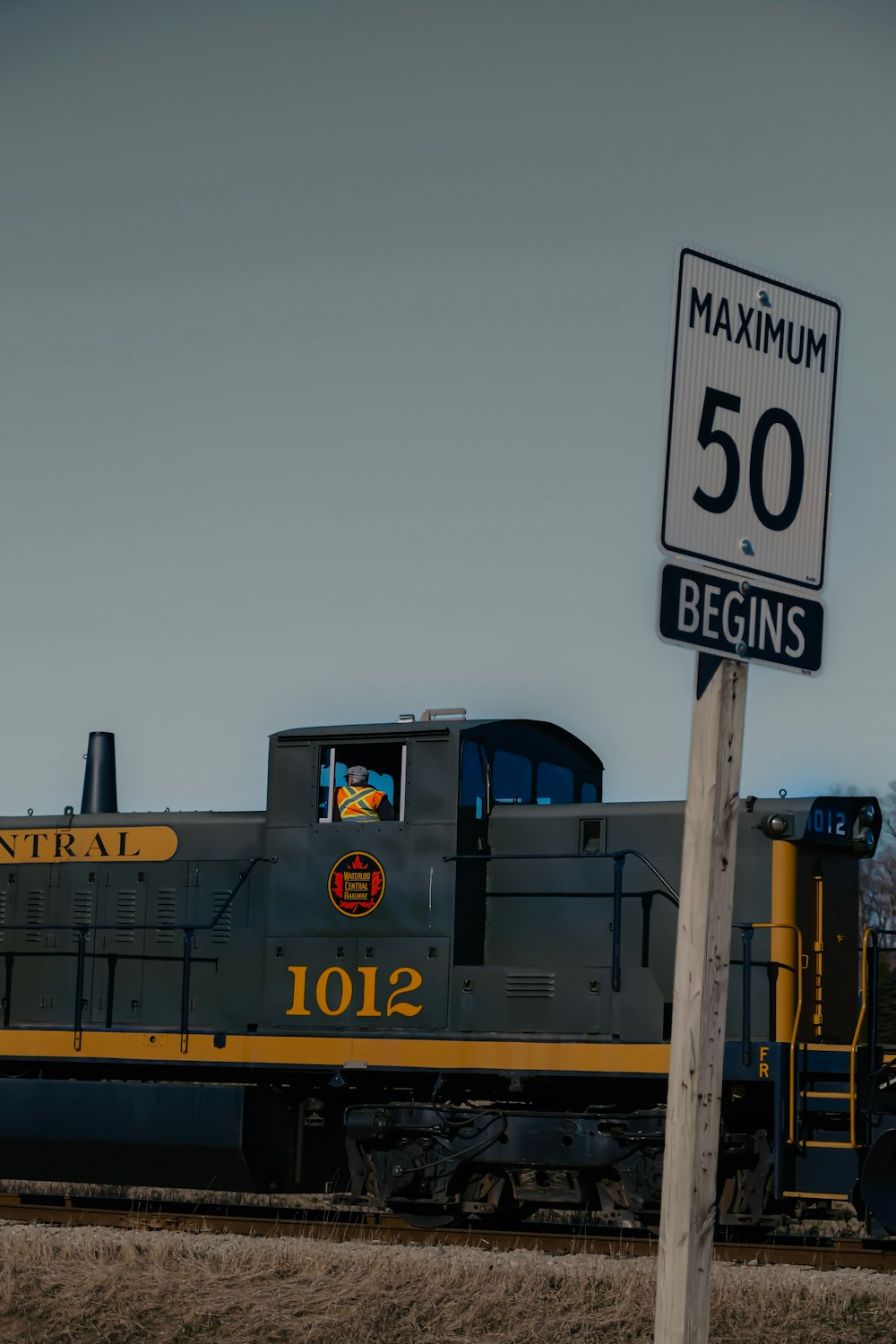 a train passing by a speed limit sign