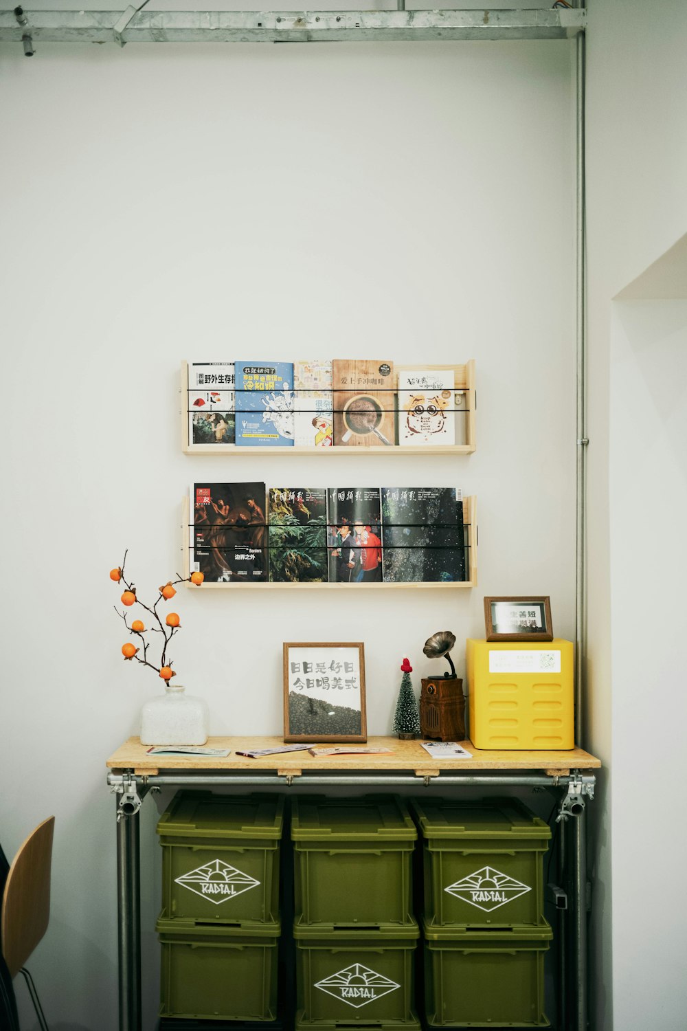 a room with a desk and some pictures on the wall