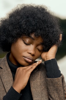 a close up of a person holding a cigarette