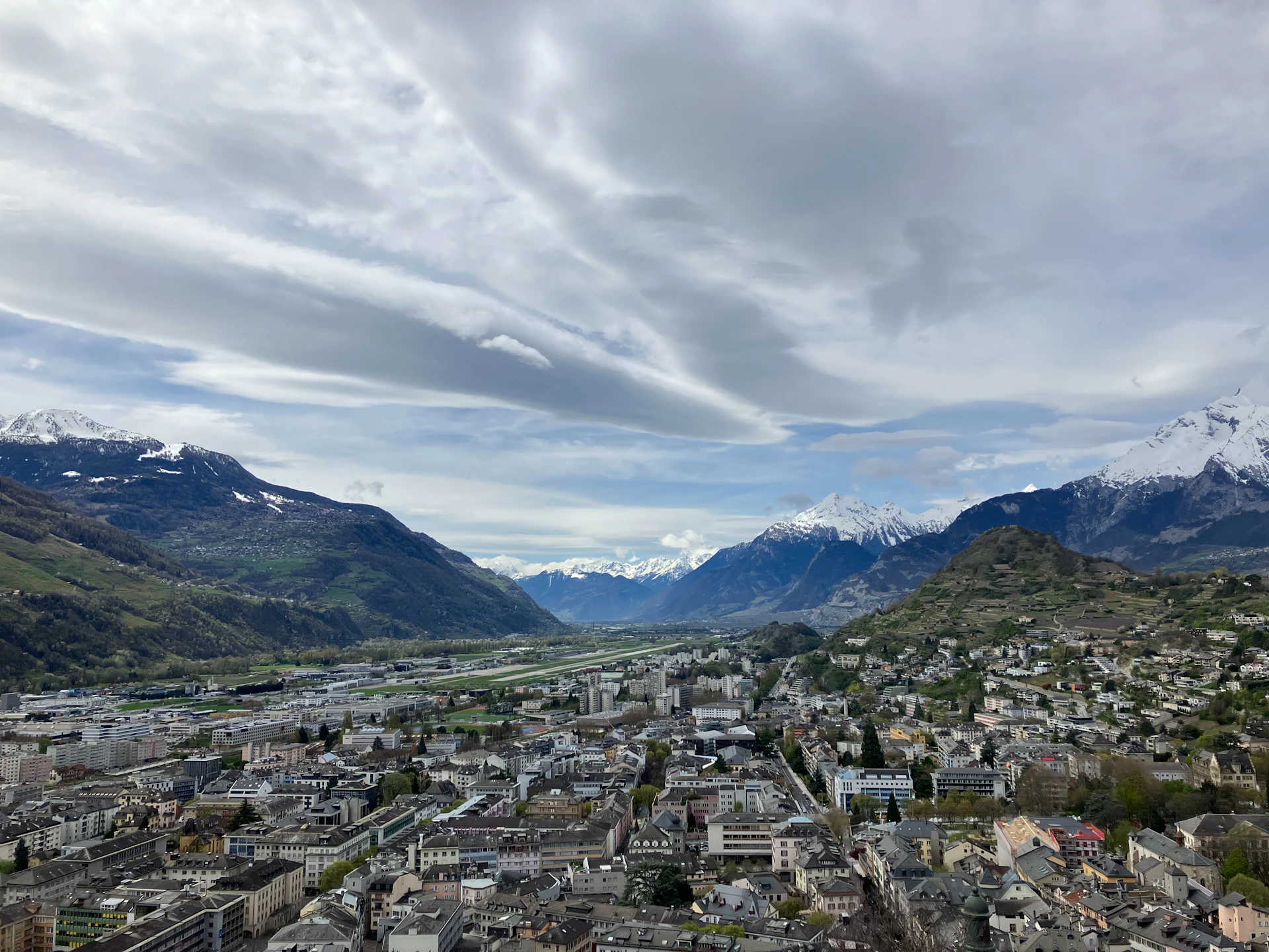 a view of a city with mountains in the background