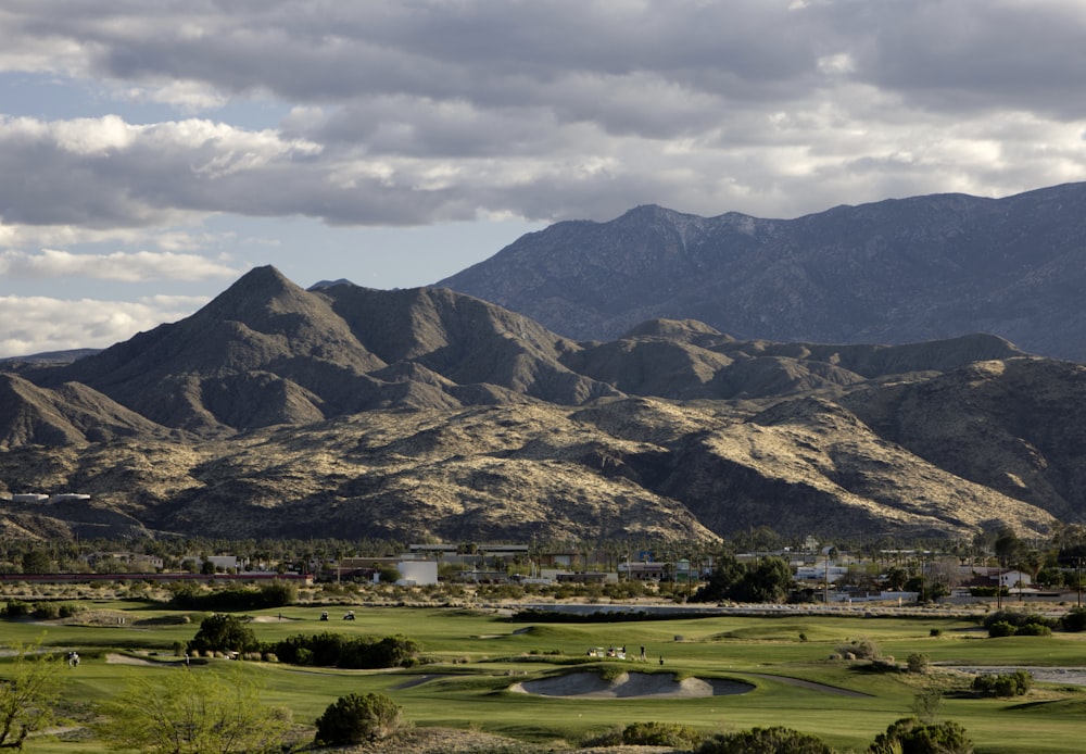 a golf course with mountains in the background