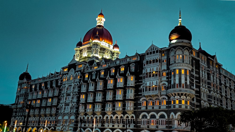 a large building lit up at night with lights on