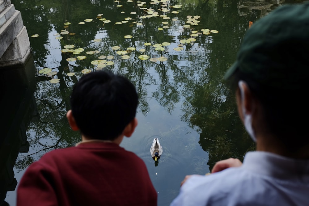 a couple of people that are looking at some water