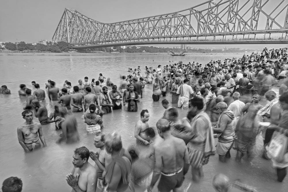 a large group of people standing in the water