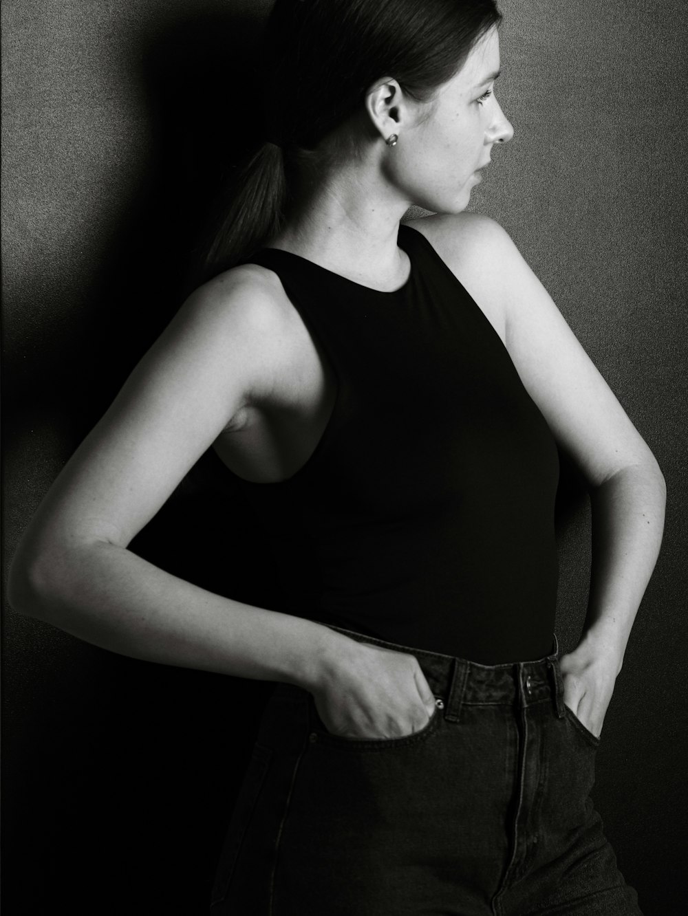 a black and white photo of a woman in a tank top