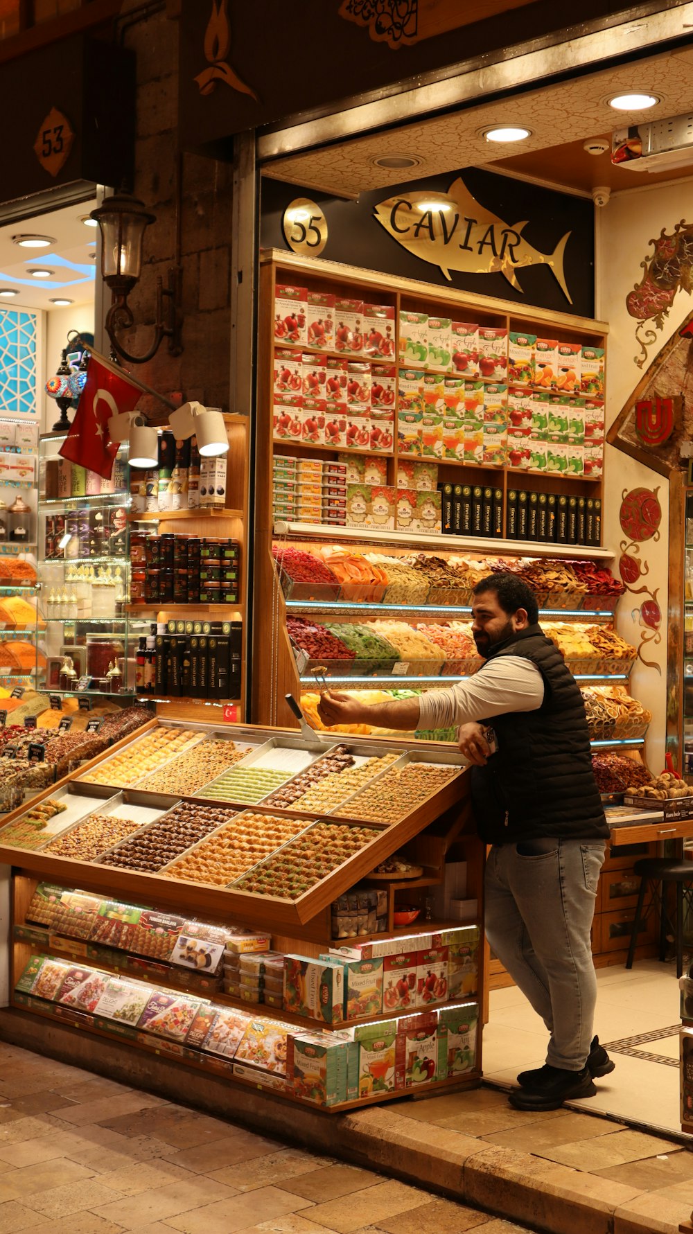 a woman standing in front of a store filled with food