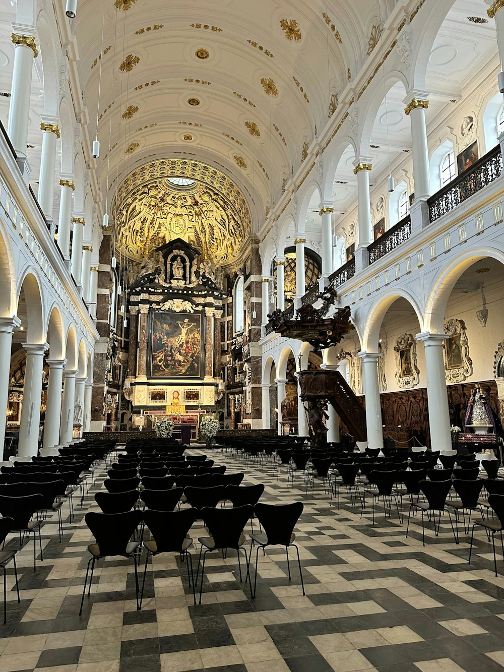a large cathedral with a clock on the ceiling
