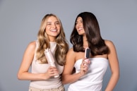 two beautiful young women standing next to each other
