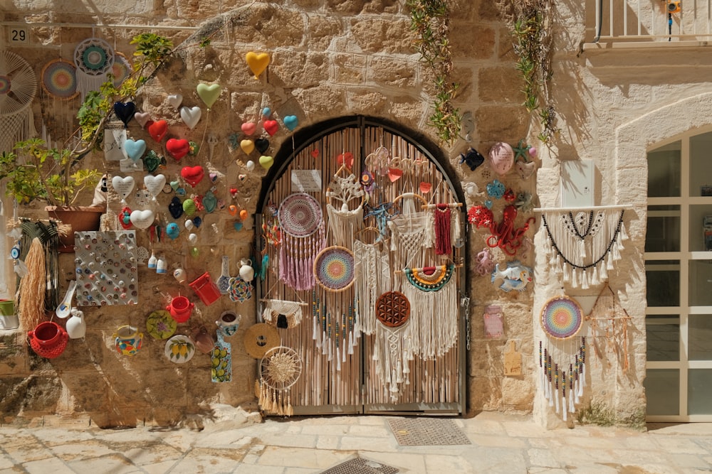 a stone wall with a door and a bunch of earrings hanging on it