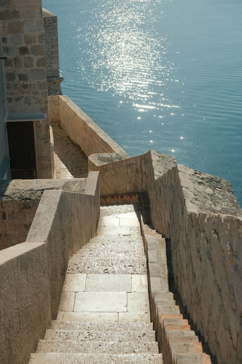 a set of stone steps leading to a body of water