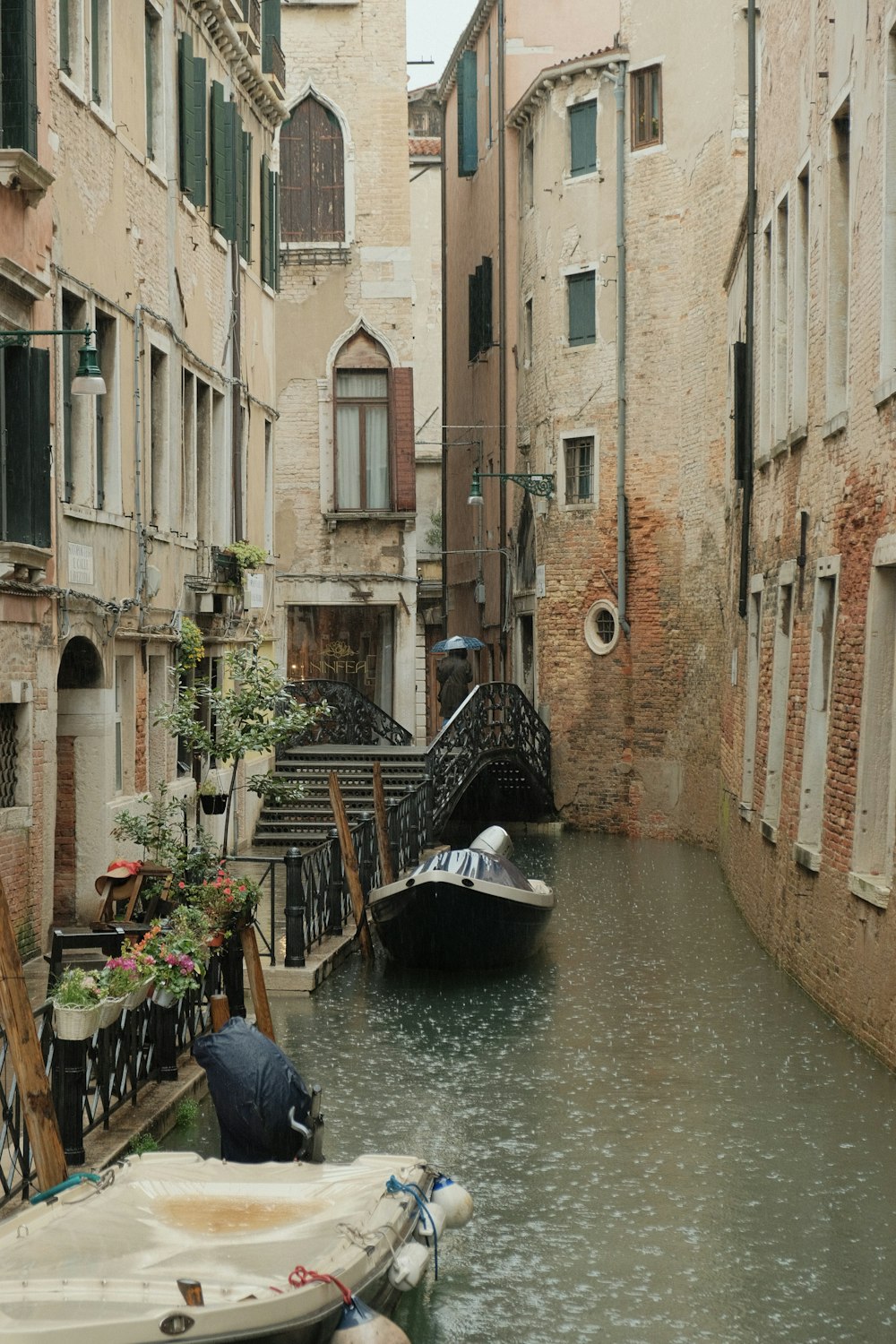 a narrow canal with a boat in the middle of it