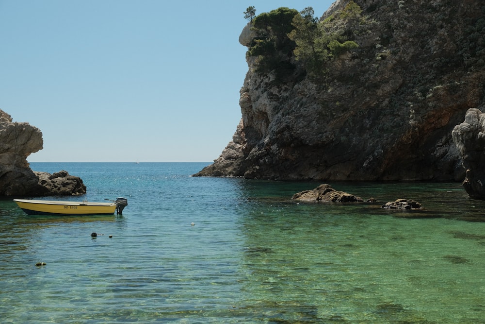 a small boat floating in a body of water