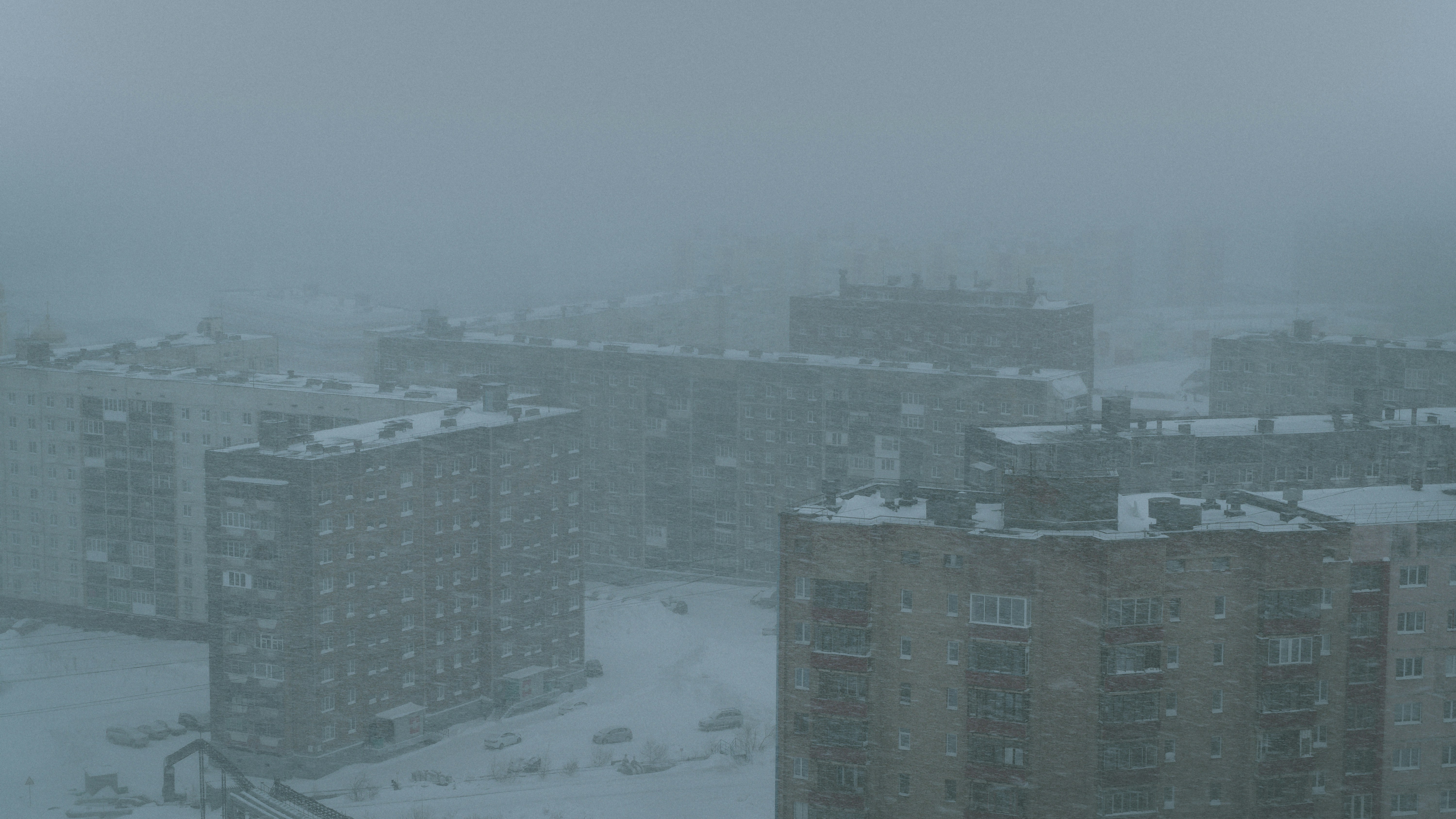 a view of a snowy city from a window