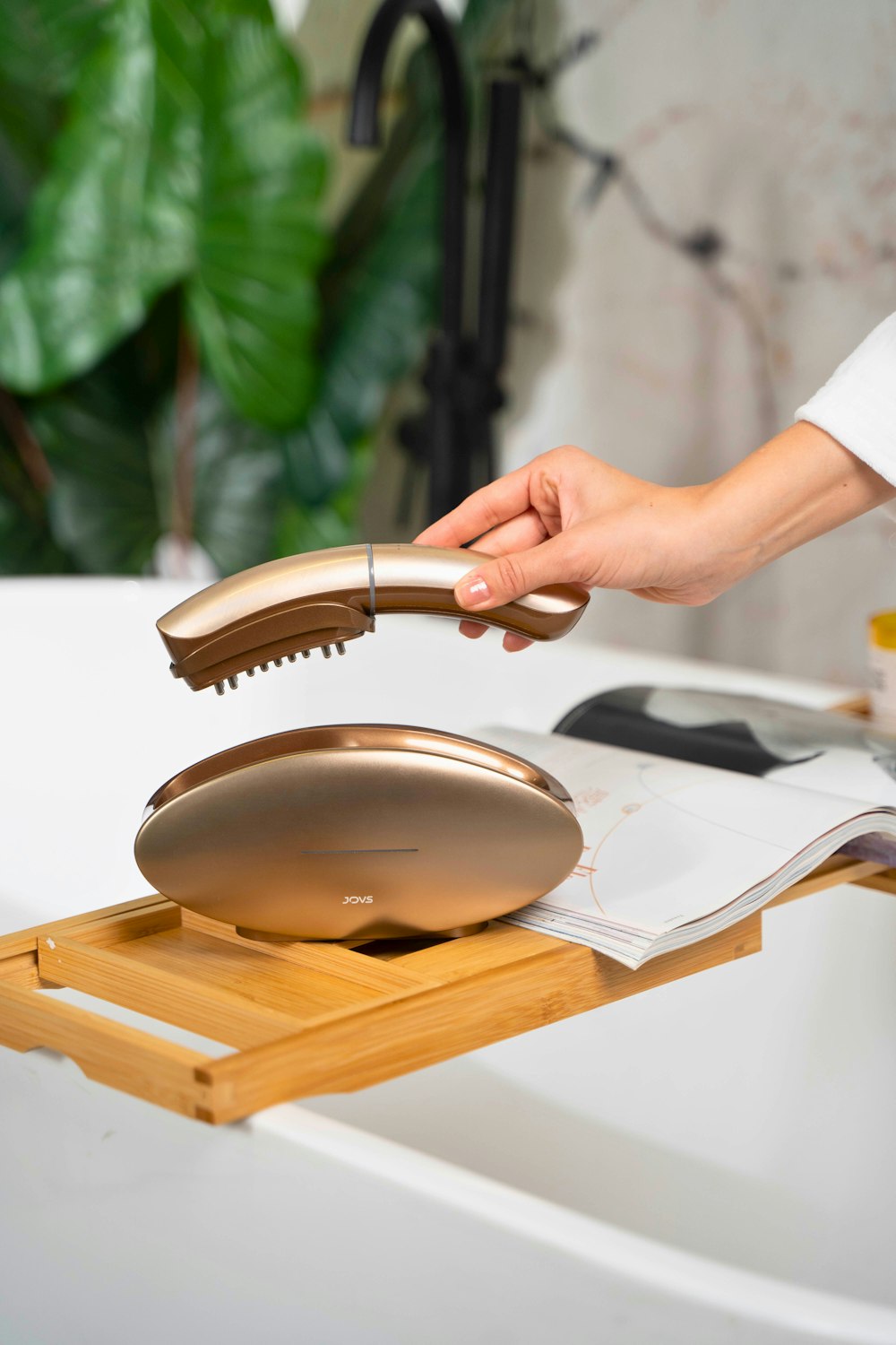 a person holding a hair dryer in their hand