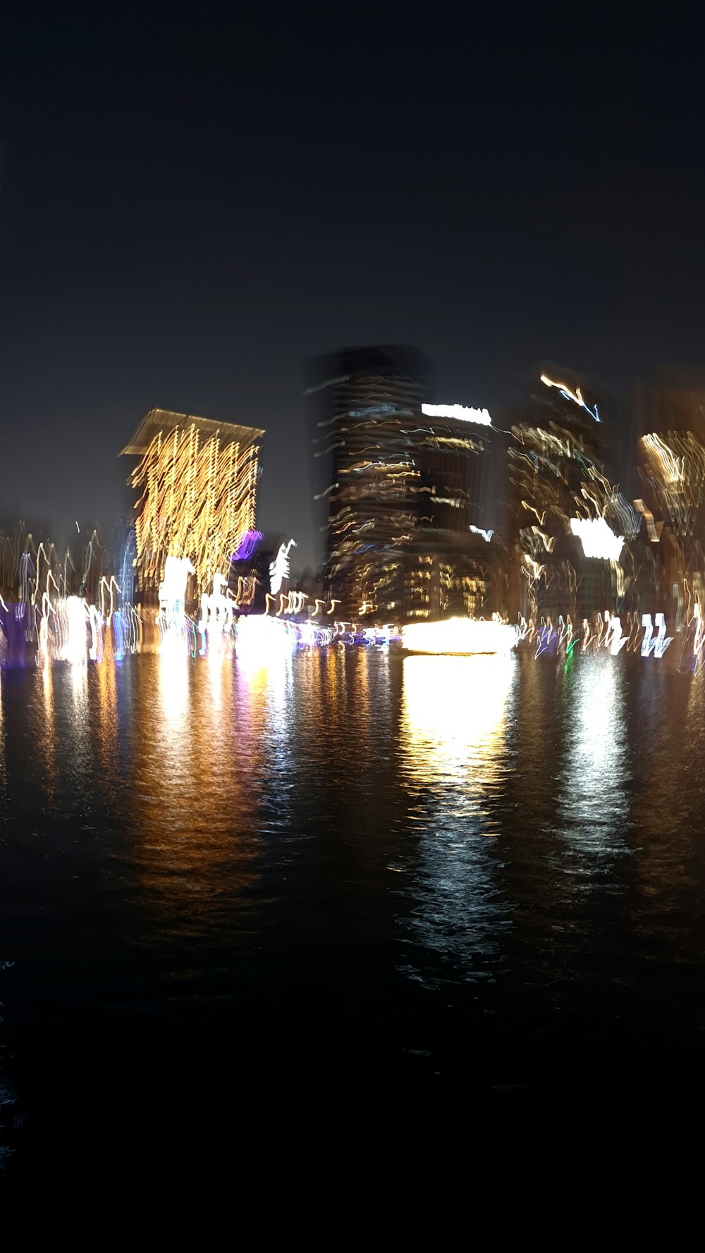 a large body of water with buildings in the background