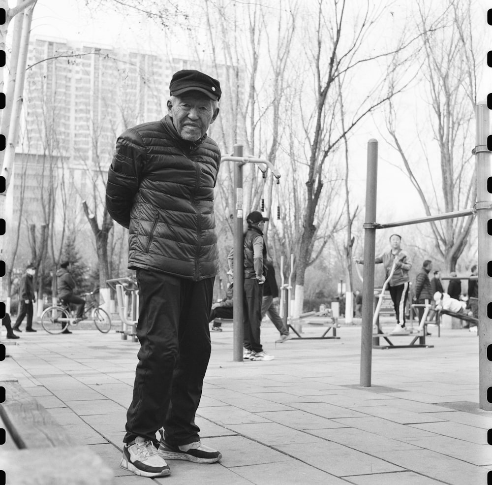 a black and white photo of a man in a park