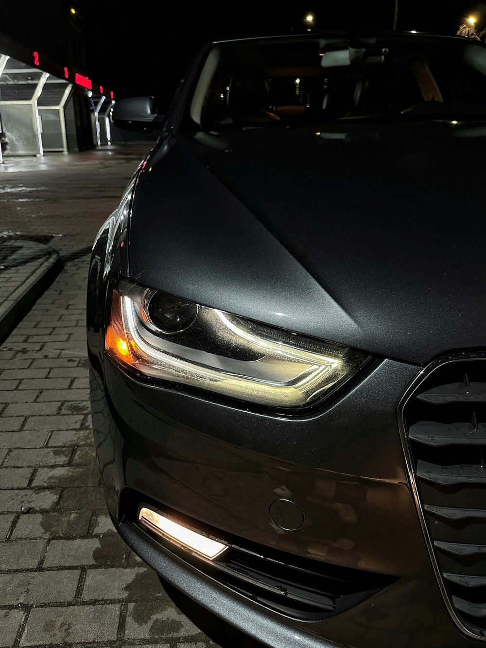 a close up of a car on a street at night