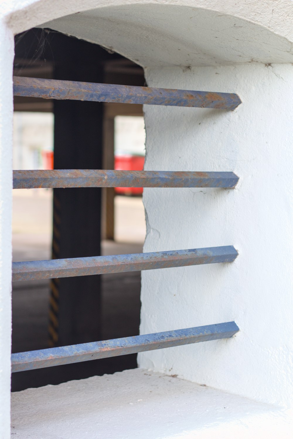 a close up of a white wall with metal bars