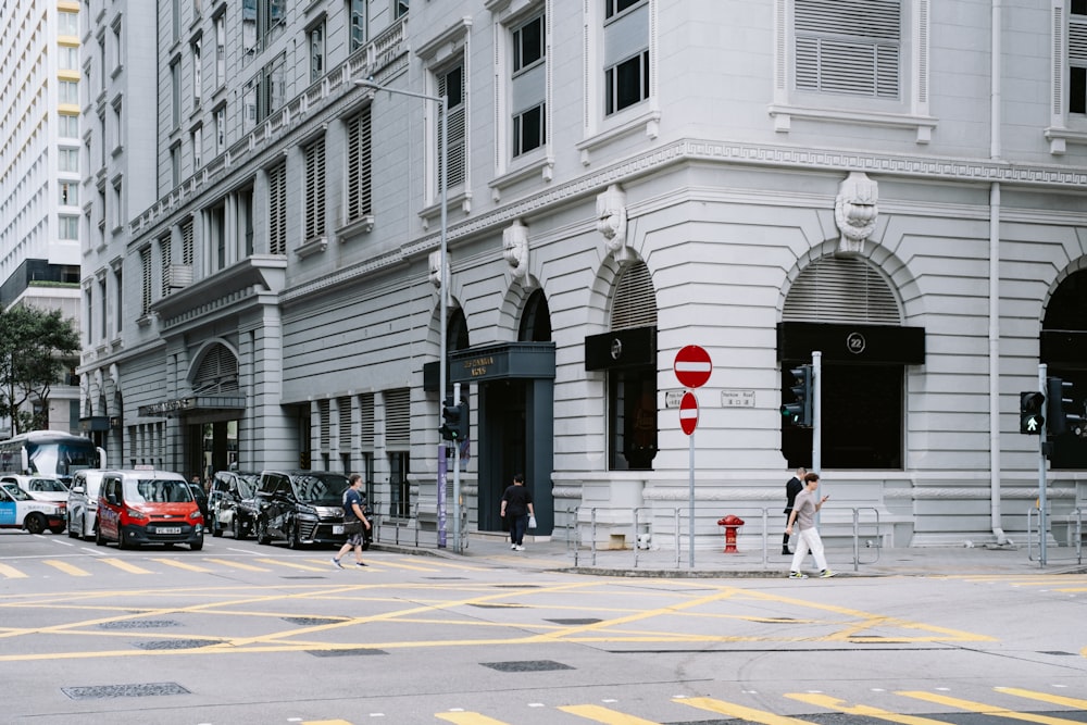 a city street filled with traffic next to tall buildings