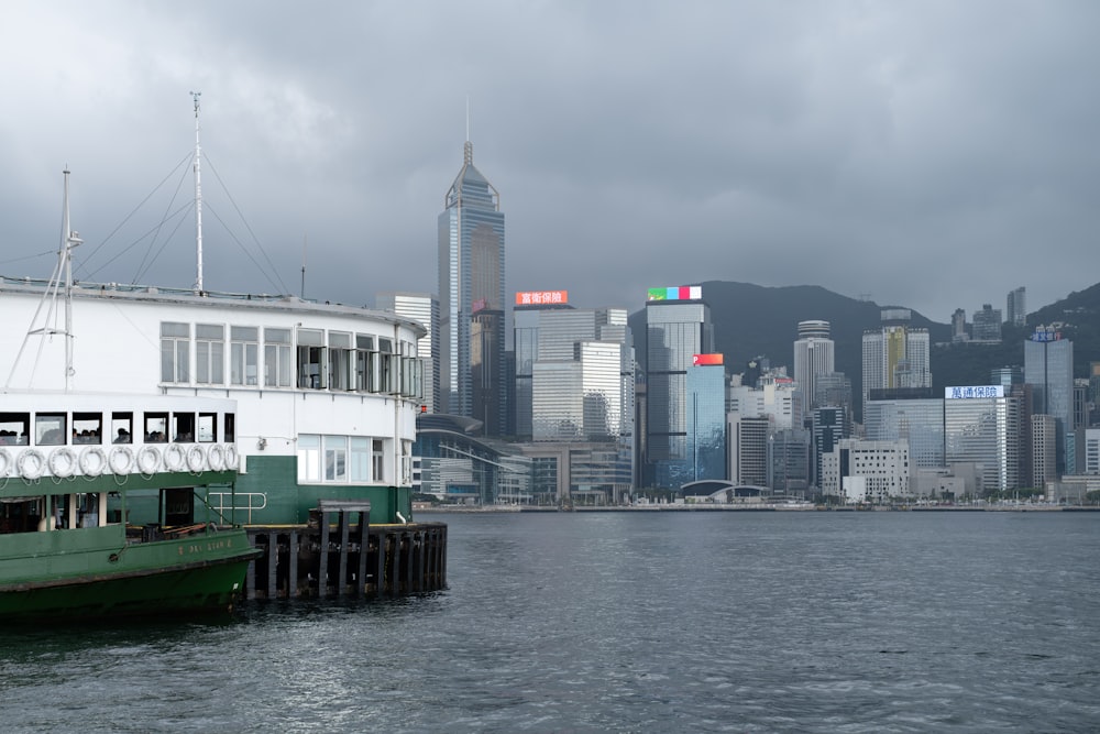 a ferry boat in the water with a city in the background