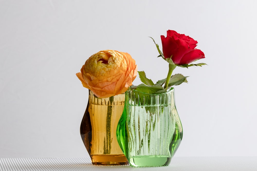 a couple of vases that have flowers in them