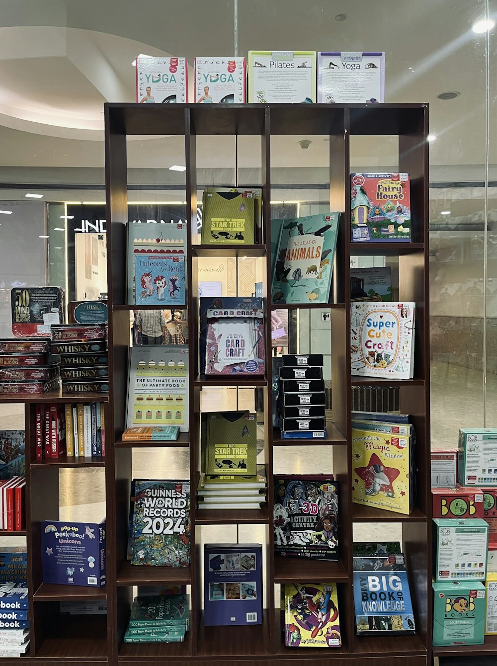 a bookshelf filled with lots of books in a store