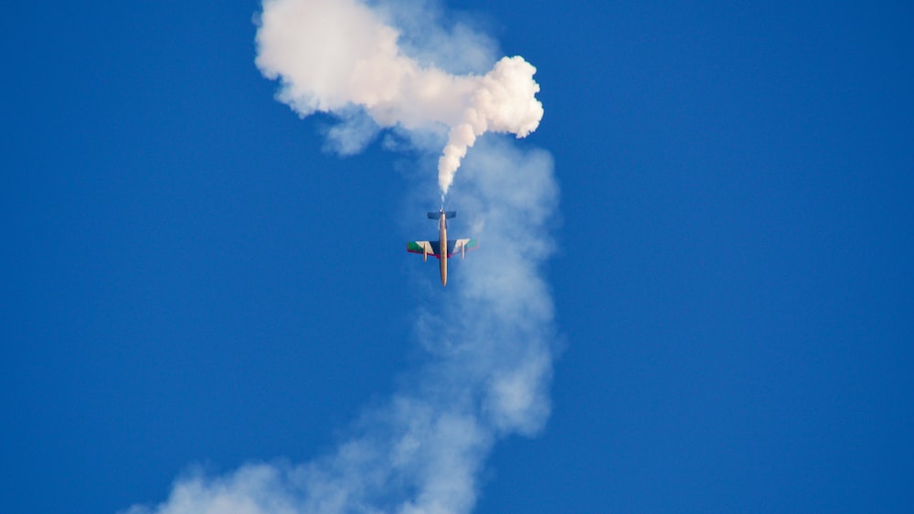 a plane is flying through the air with a lot of smoke coming out of it