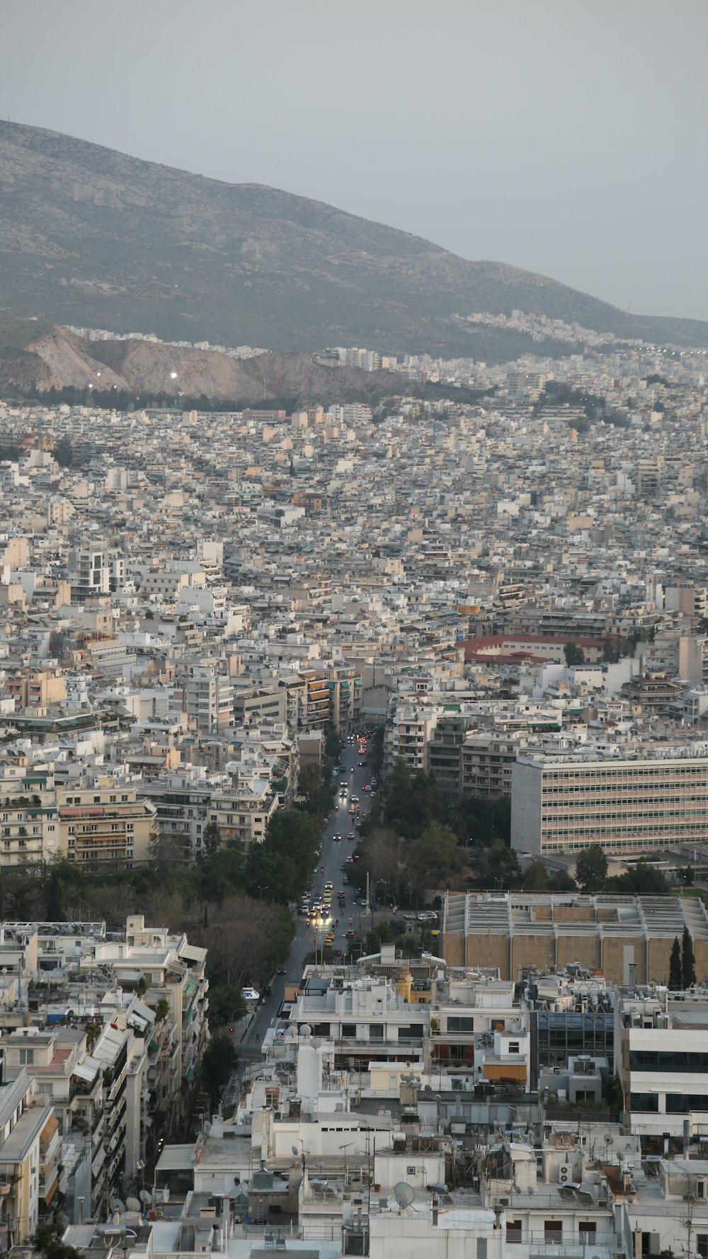 a view of a city with a hill in the background