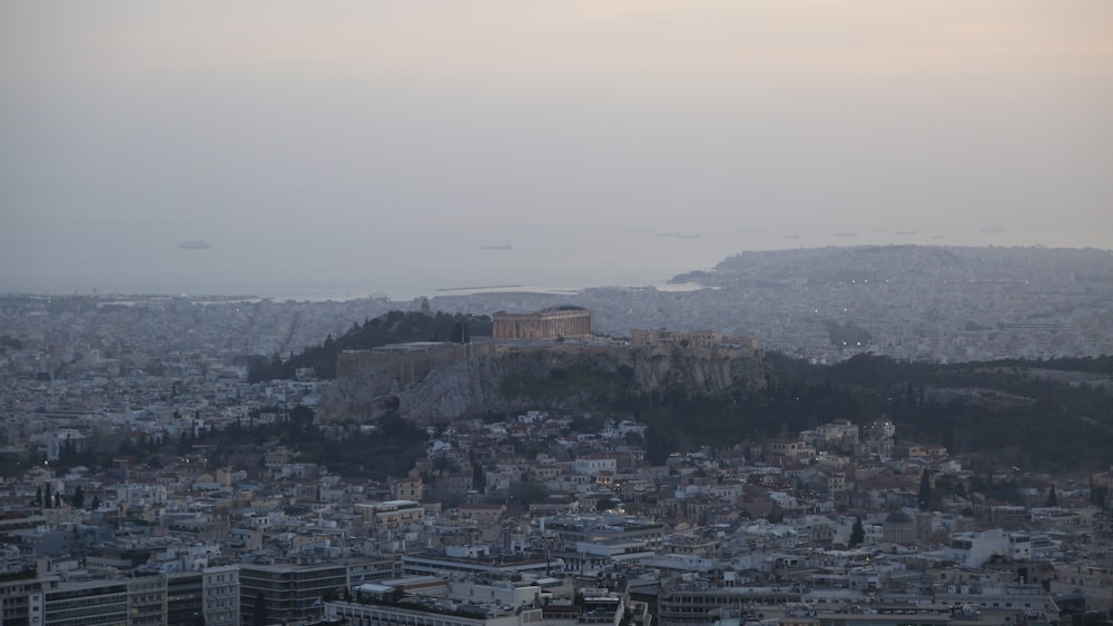 a view of a city with a hill in the background