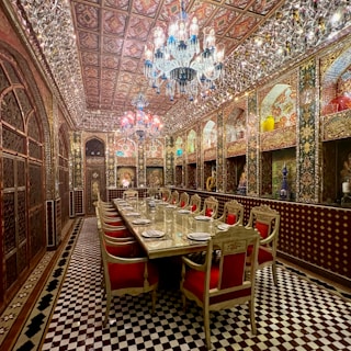 a fancy dining room with a chandelier hanging from the ceiling
