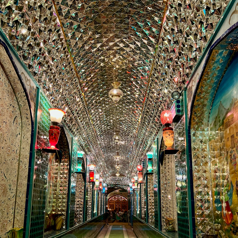 a very long hallway with a lot of lights on the ceiling