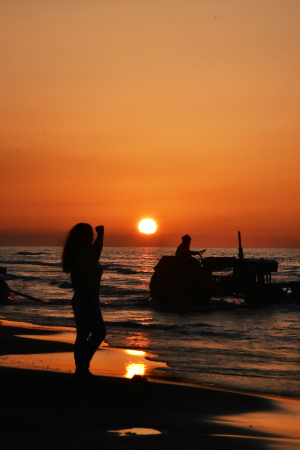 a couple of people standing on top of a beach