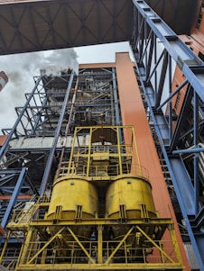 a very tall building with lots of yellow pipes