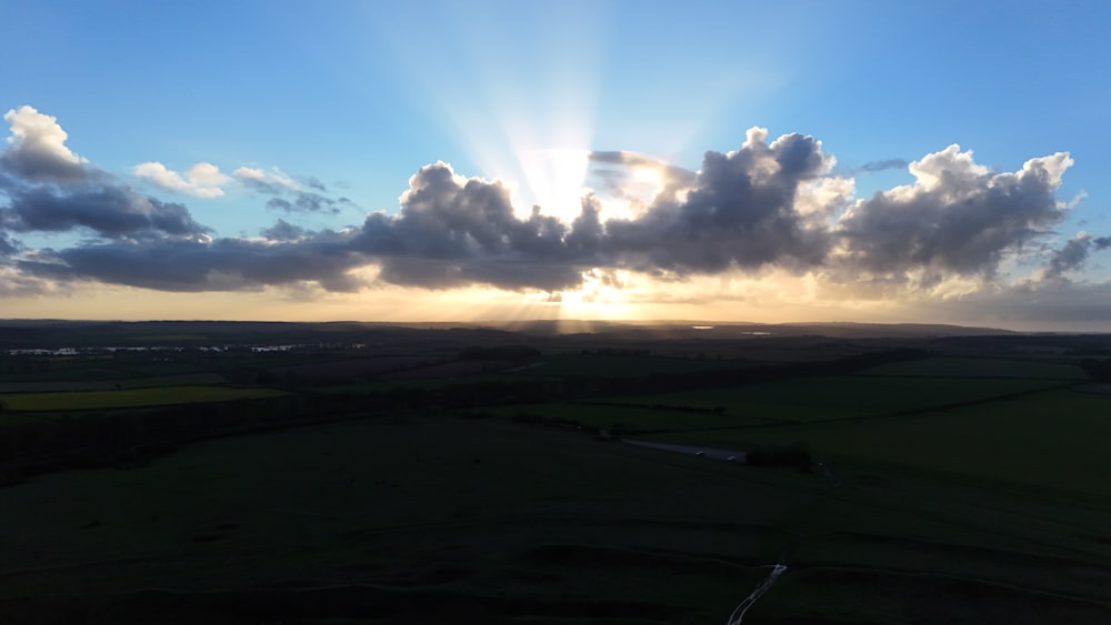 the sun is shining through the clouds in the sky