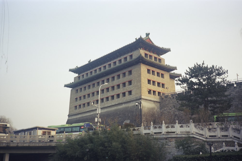 a tall building with a bridge in front of it