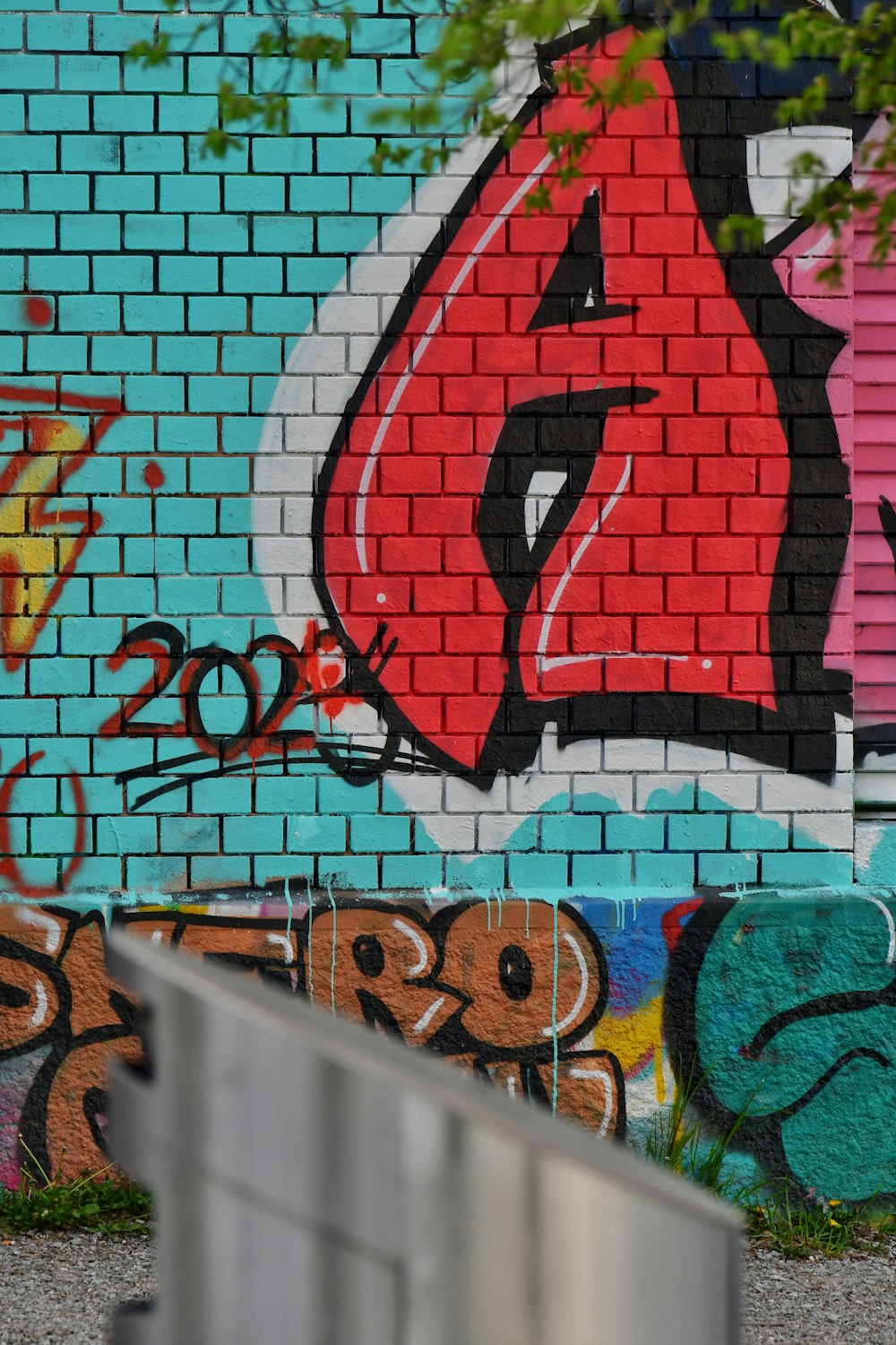 a man riding a skateboard past a graffiti covered wall