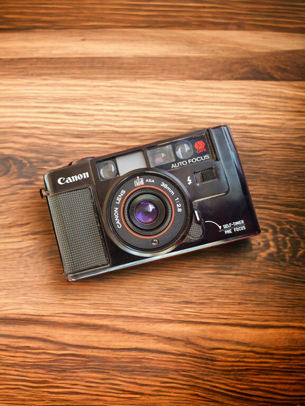 a camera sitting on top of a wooden table