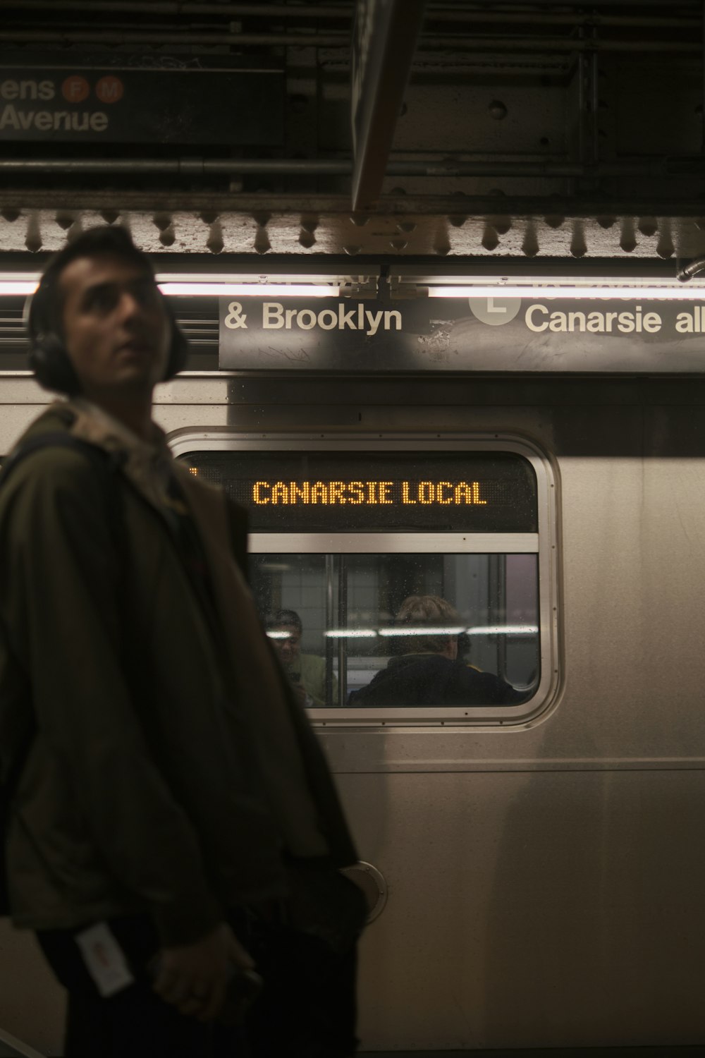 a man standing in front of a subway car