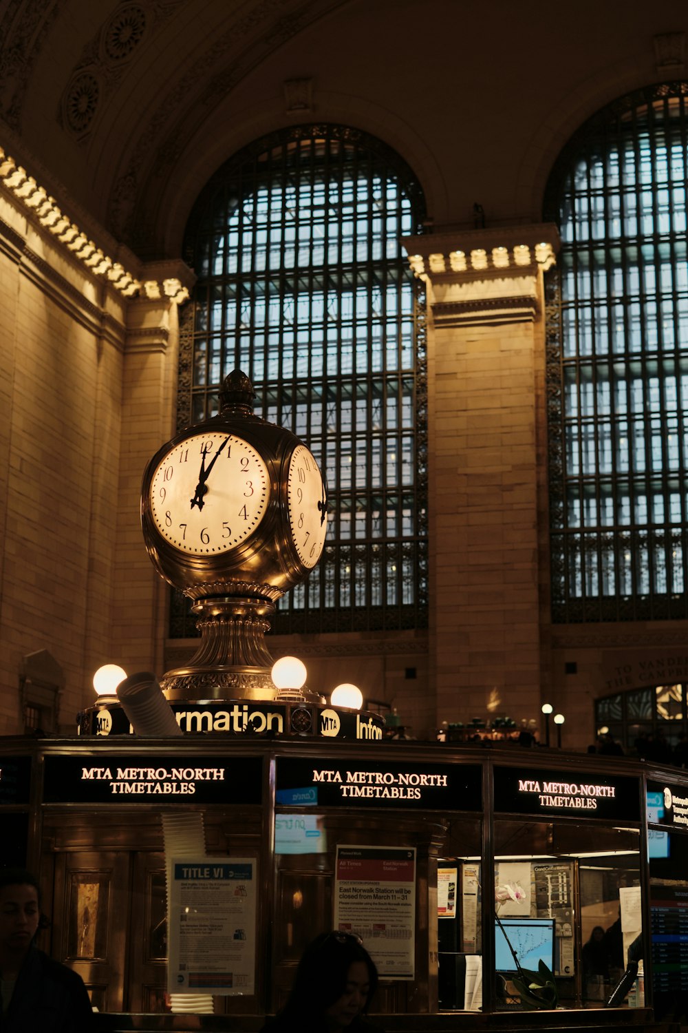 a train station with a clock in the middle of it