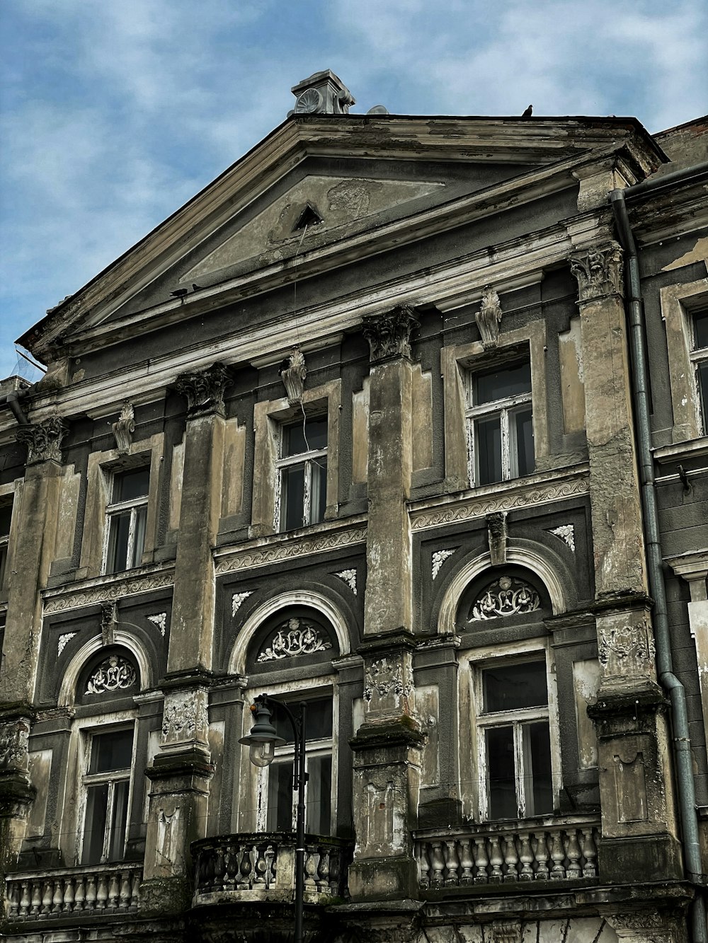 an old building with a clock on the top of it