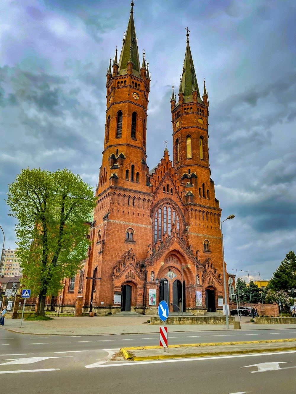 a large red brick church with two towers