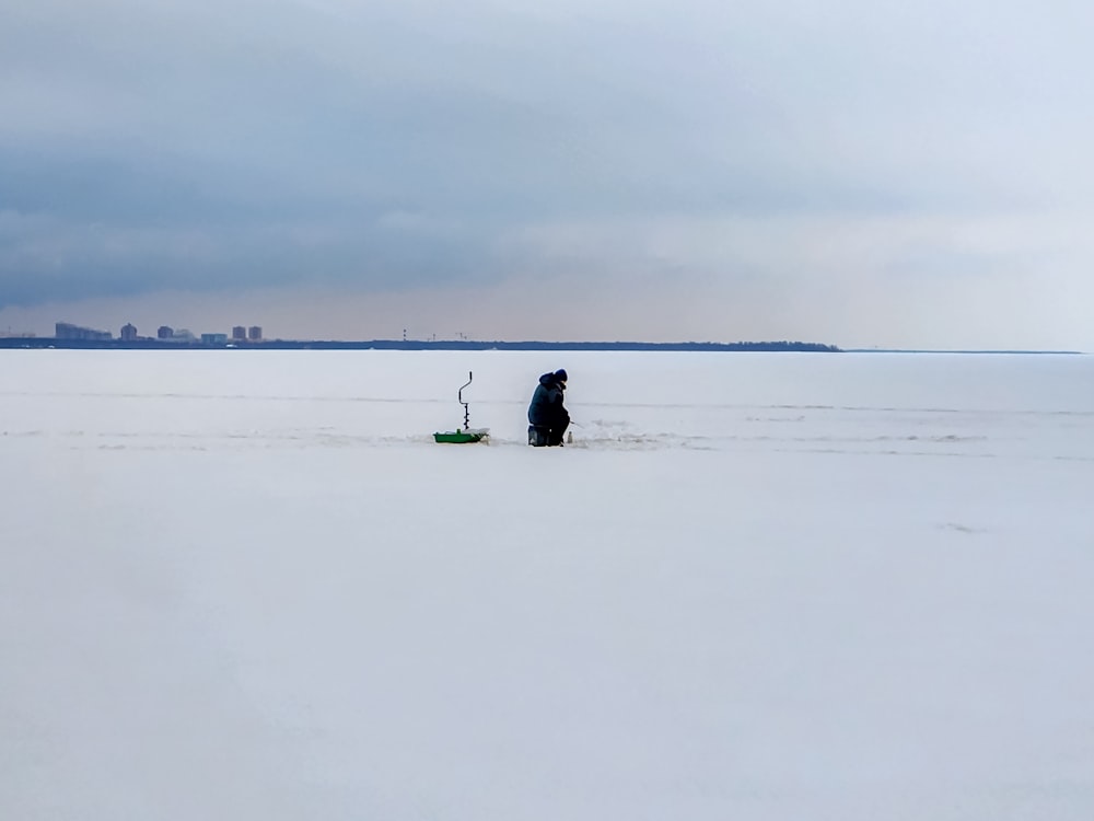 a person standing in the middle of a snow covered field