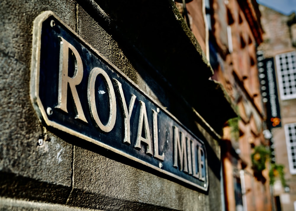 a close up of a street sign on a building