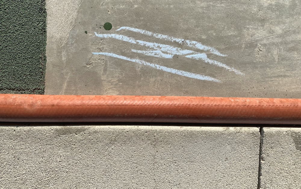 a close up of a sidewalk with graffiti on it